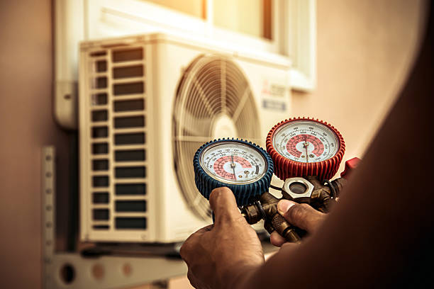 Professional Hvac technician working in Raynham Center, MA